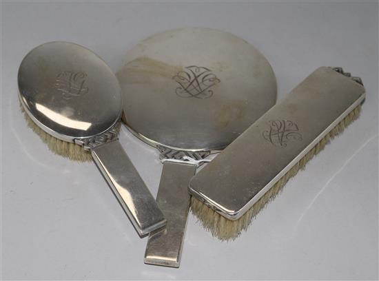 A stylish 1940s Danish silver mounted three piece brush and mirror set by Johannes Siggaard, mirror 23.3cm.